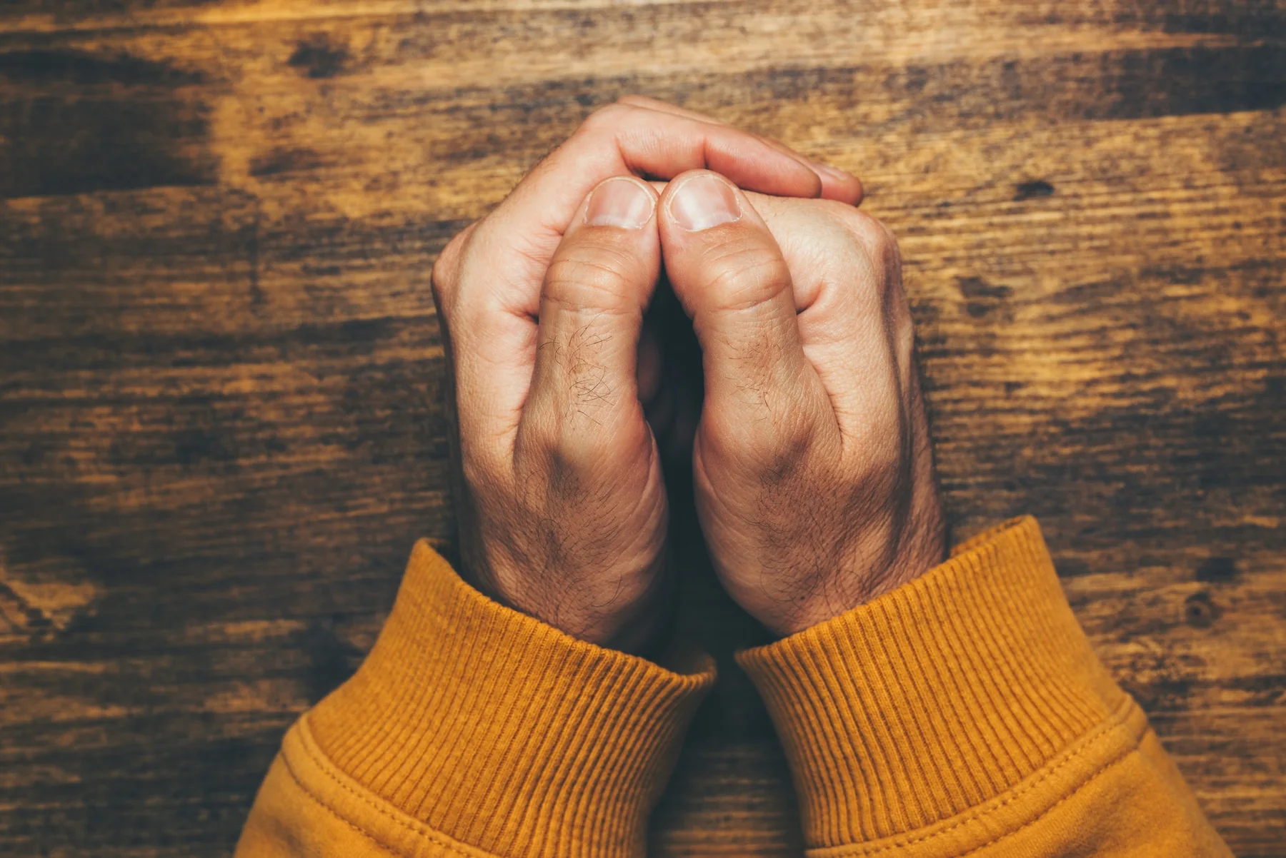Hands clasped together in prayer
