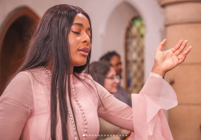 A woman worshipping during a church service