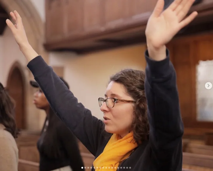 A woman raising her hands in worship